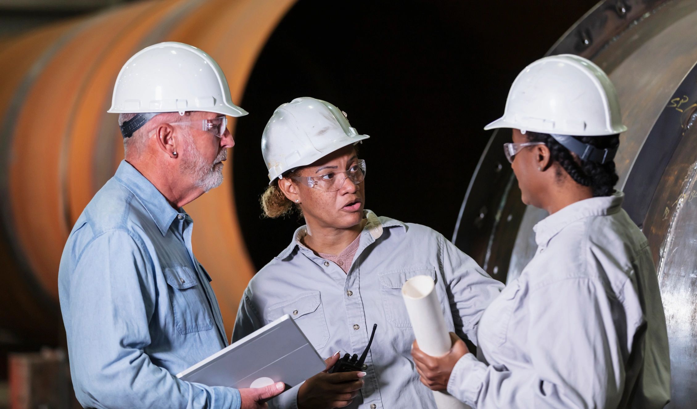 Industrial professionals meeting on a manufacturing floor