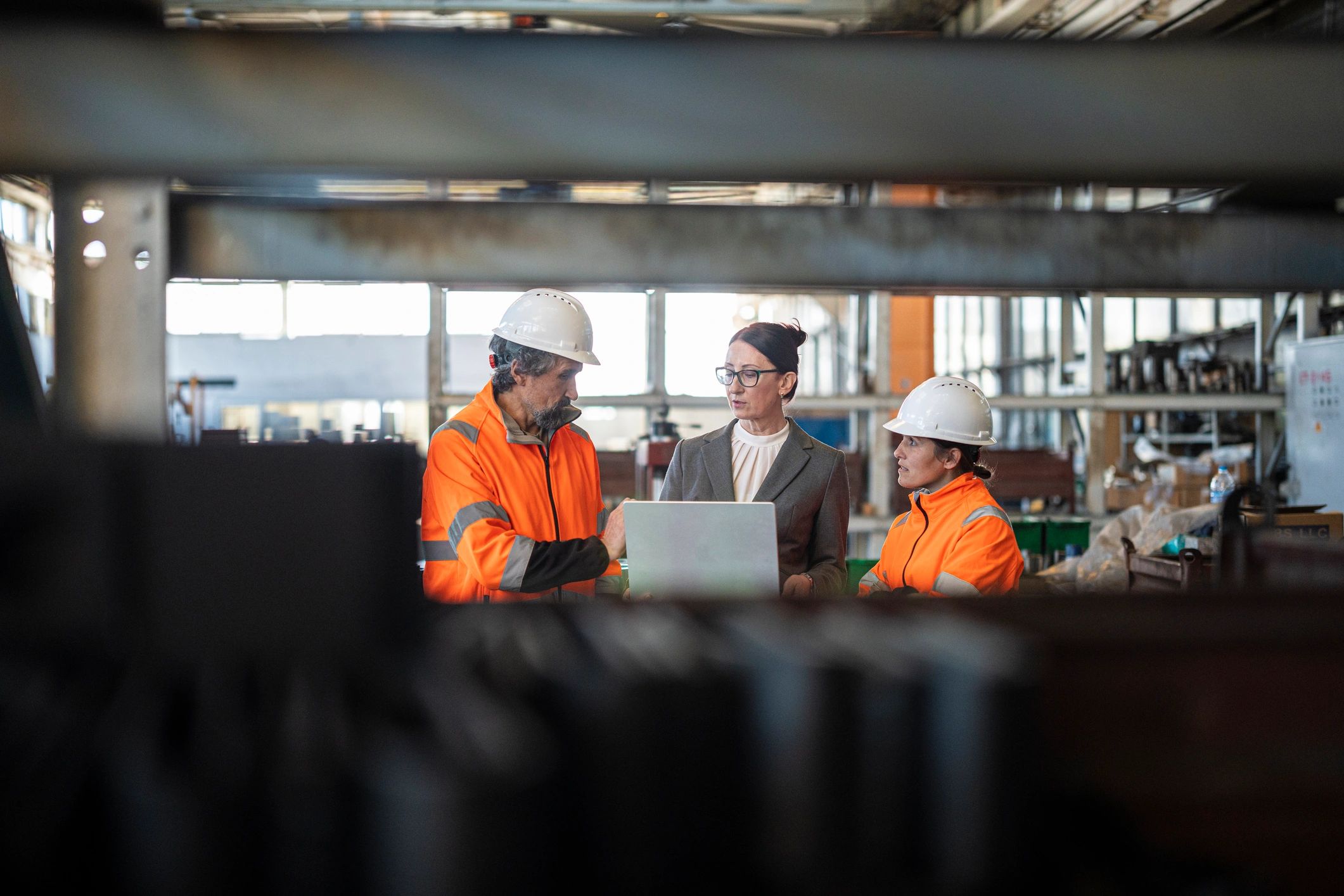 Industrial team discussing operations on a factory floor